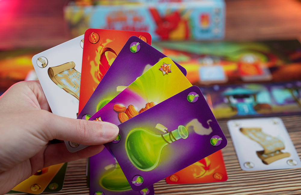 A hand of colorful treasure cards from Please Don't Burn My Village