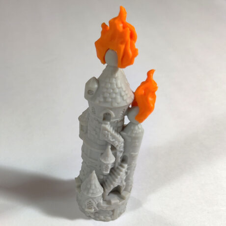 Plastic mini of The Wizard's Tower with plastic orange flame pieces attached