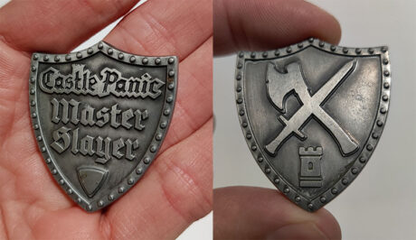 Shield shaped silver coin with Castle Panic Master Slayer text