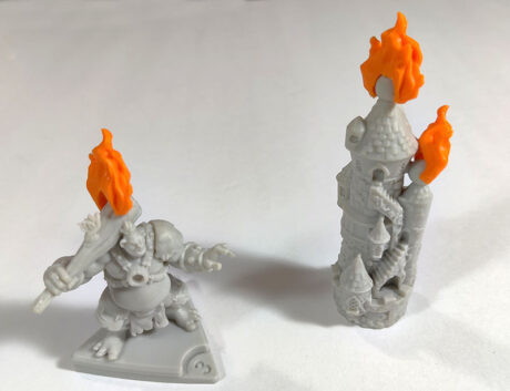 The Wizard's Tower and a troll mini with orange flame pieces attached